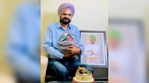 Balkaur Singh, father of Sidhu Moose Wala, joyfully shares a picture with their newborn baby boy, celebrating the newest addition to their family.